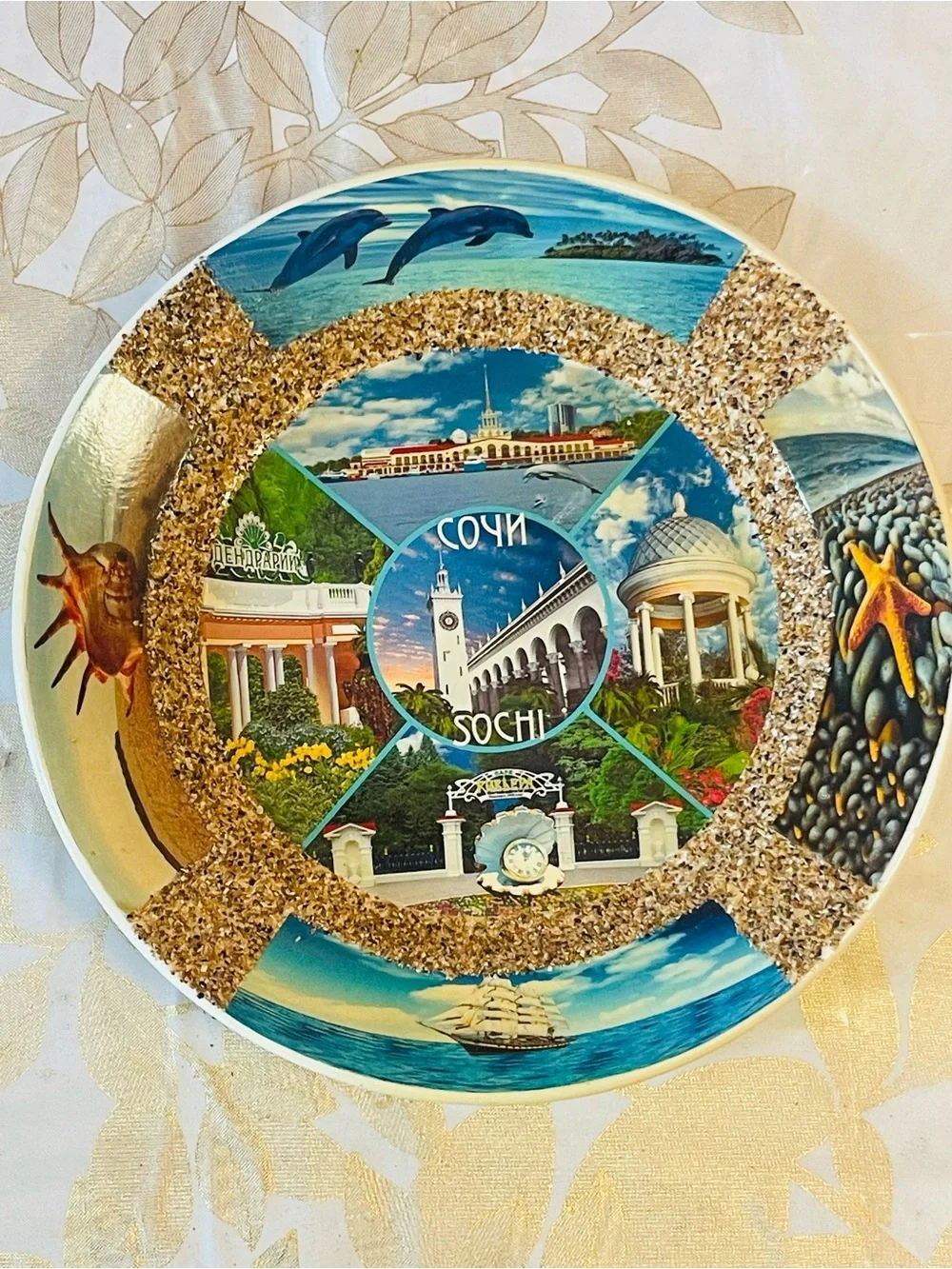 VTG decorative ceramic souvenir plate featuring scenes of Sochi, Russia.